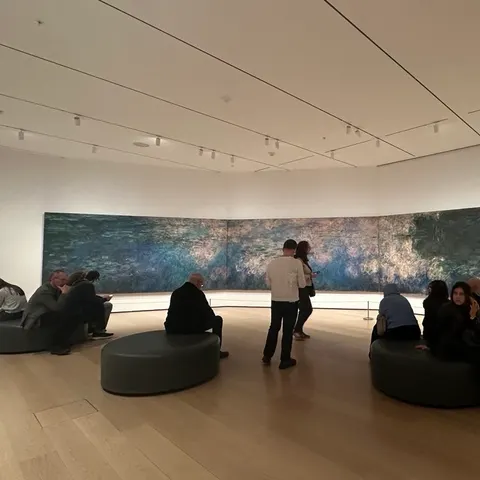 A gallery room with a long landscape painting