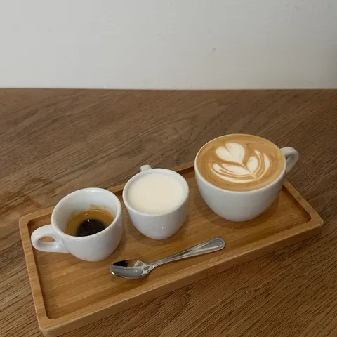 A coffee flight on a wooden tray