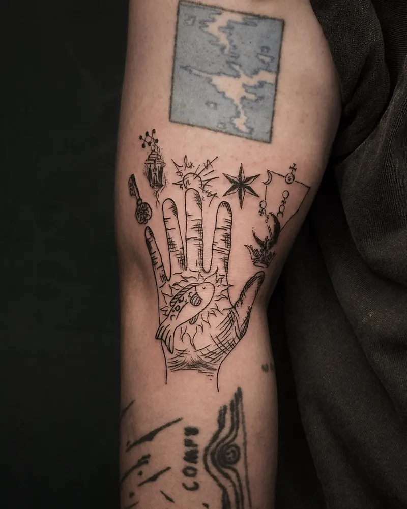 Tattoo work: a hand holding a candle below a small framed landscape, on an arm