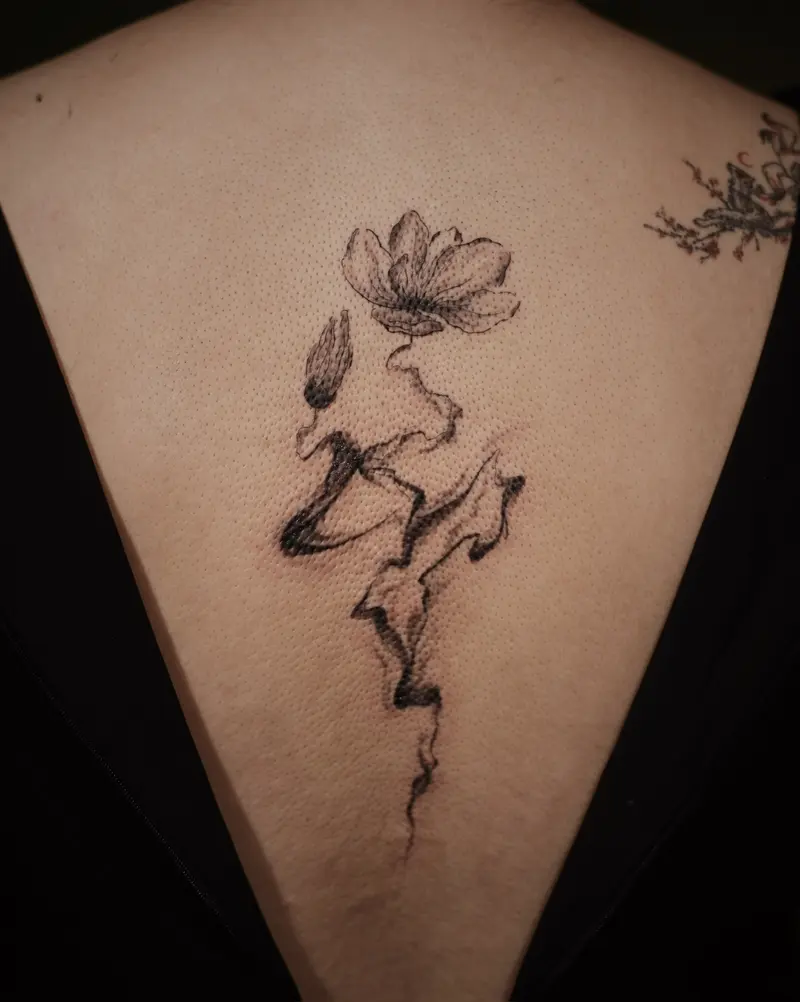 Tattoo work: a magnolia branch, on a sternum