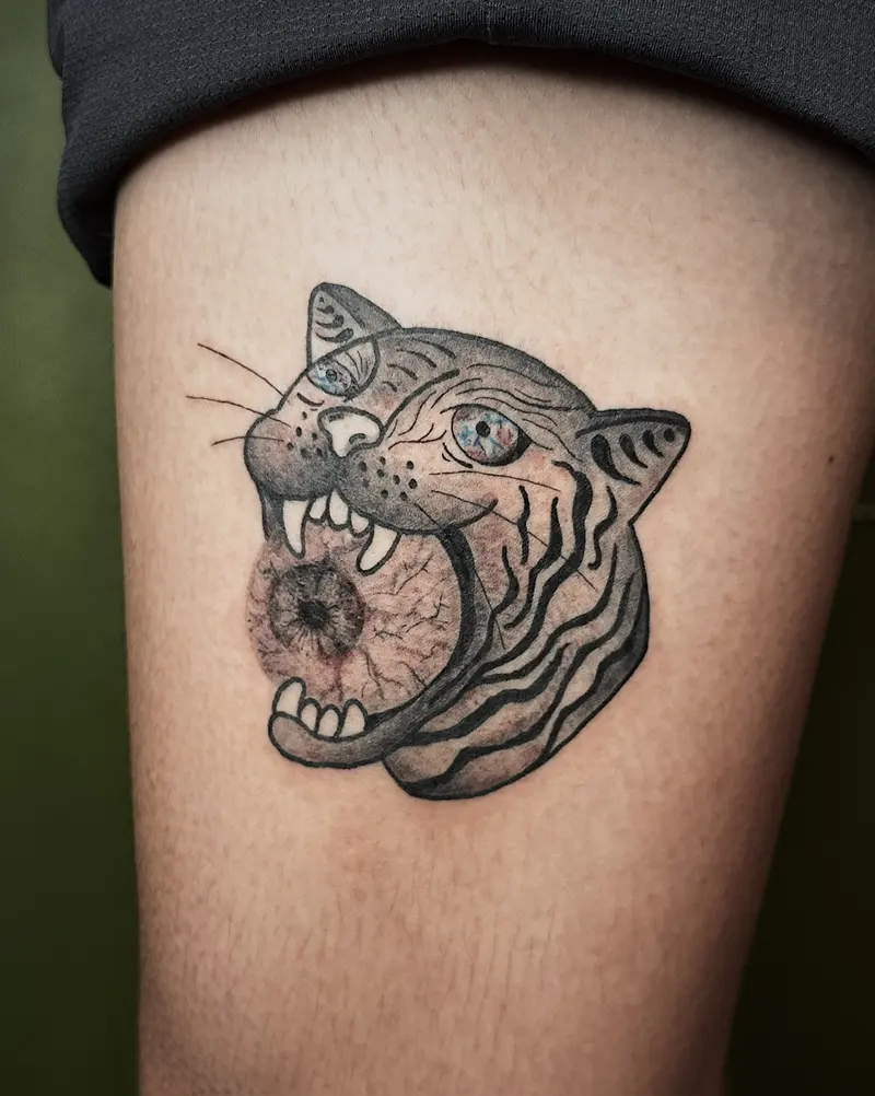 Tattoo work: a tiger’s head in colour, on a thigh