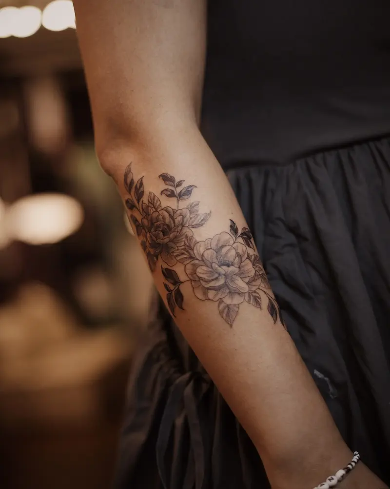 Tattoo work: soft florals wrapping an upper arm