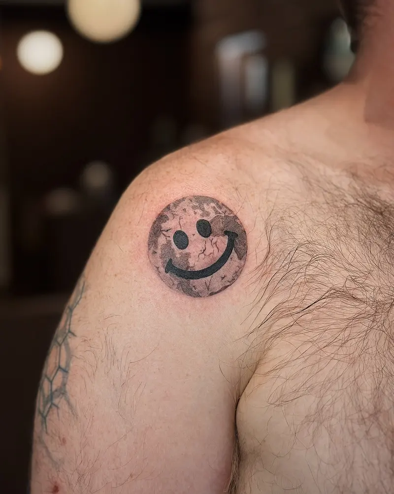 Tattoo work: a small smiley face, on a shoulder
