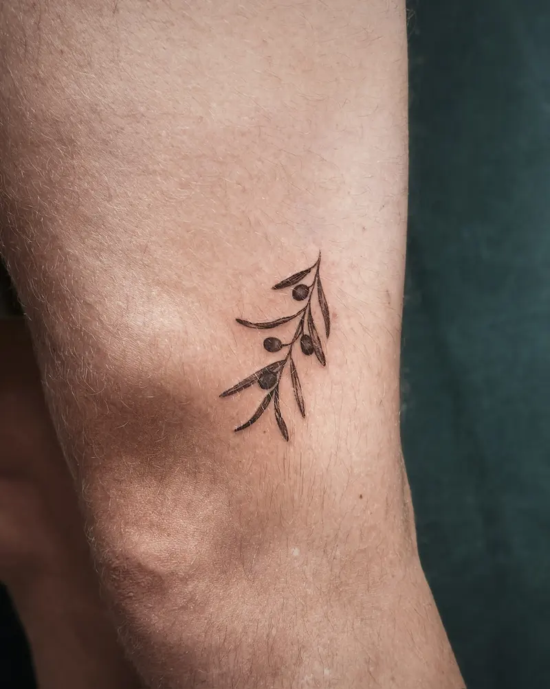 Tattoo work: a slender sprig, on an inner arm