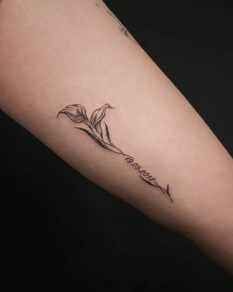 Tattoo work: a bird trailing into fine line script down a forearm