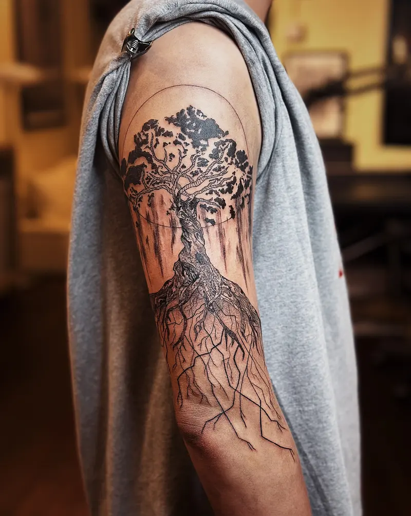 Tattoo work: a dense black and grey piece covering an upper arm